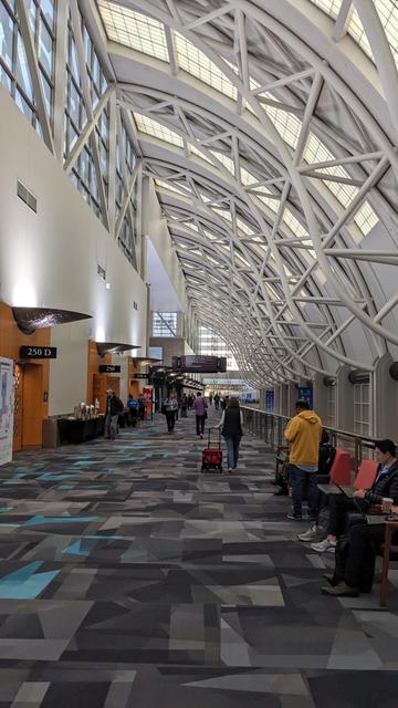 convention center hall, signs for kubecon can be seen