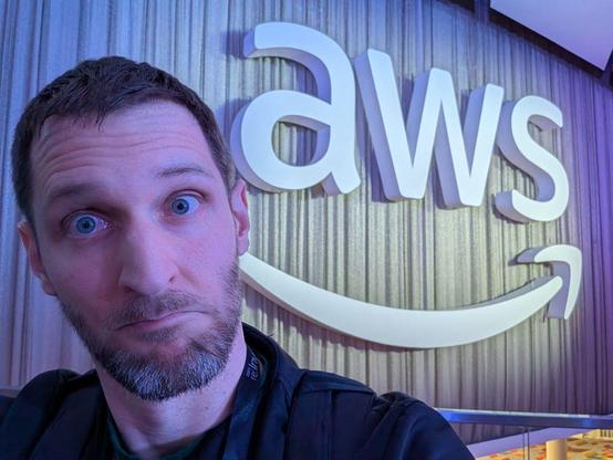 A picture of my head next to the AWS logo at reInvent 2024