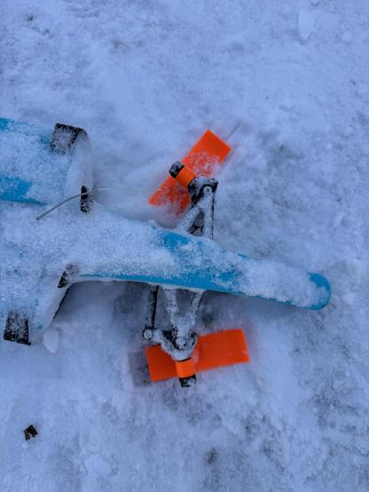 A top-down photo of the front skis of the OpenRC F1 car showing how the steering would get locked to one side because of the geometry of the steering linkage. The car required frequent rescues and resets because of this.