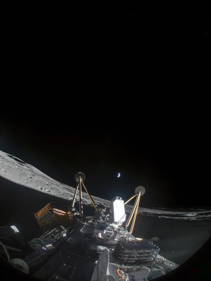 Fisheye picture from the lunar surface taken by a camera attached to the top of the IM2 lander. The lander has fallen over on it's side and the legs point towards the small half lit earth in the far distance.
The crater partially lies in the shade, which covers most of the foreground. A small hill is visible on the horizon. 
fisheye picture from the lunar surface taken by a camera attached to the top of the IM2 lander. The lander has fallen over on it's side and the legs point towards the small half lit earth in the far distance.
The crater partially lies in the shade, which covers most of the foreground. A small hill is visible on the horizon. 