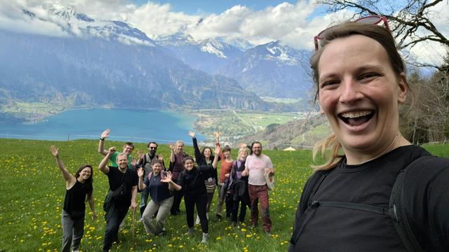 A group of hikers and view of mountains and the lake