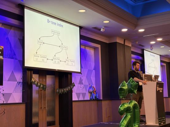 Adam on stage explaining b-trees 🤯