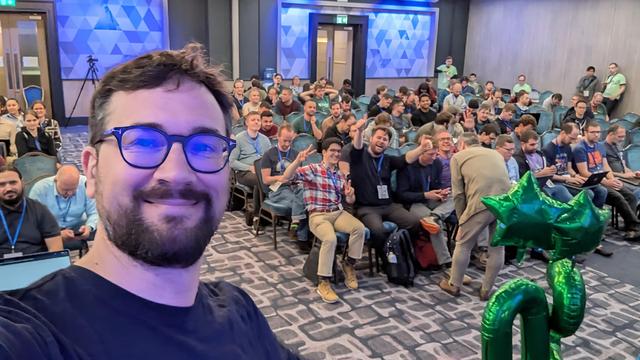 Me taking a selfie in front of a room full of people 