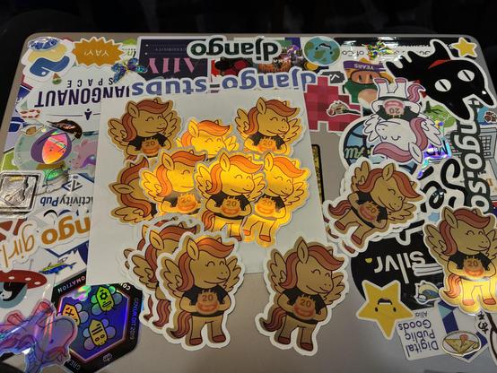 Stickers of a shiny golden pony on a laptop