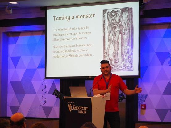 Vince in front of a "Taming a monster" slide on the conference stage