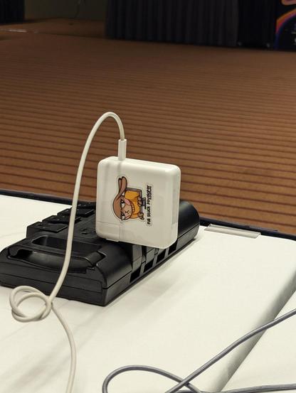 MacBook laptop charger with sticker. Typo of the day: Full Stuck Developer