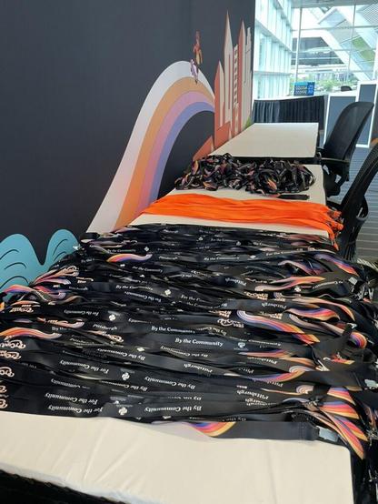 Hundreds of PyCon US 2025 lanyards laid out neatly behind the registration desk and ready to be handed to attendees.