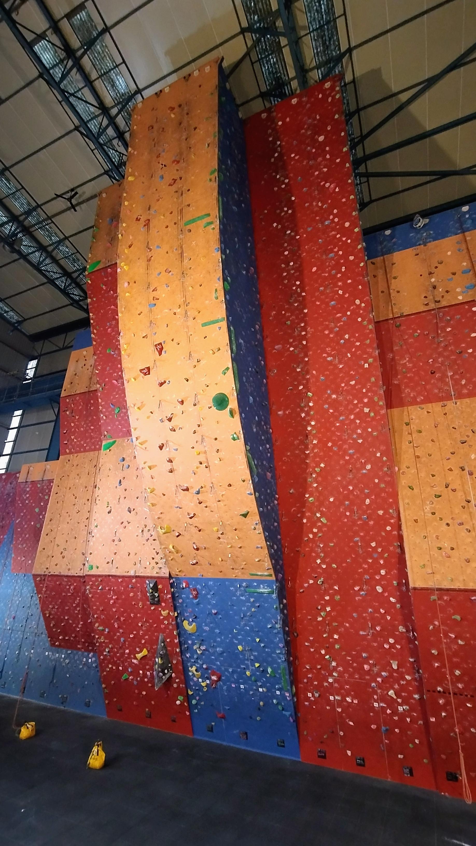Slightly tall and colourful indoor climbing wall.