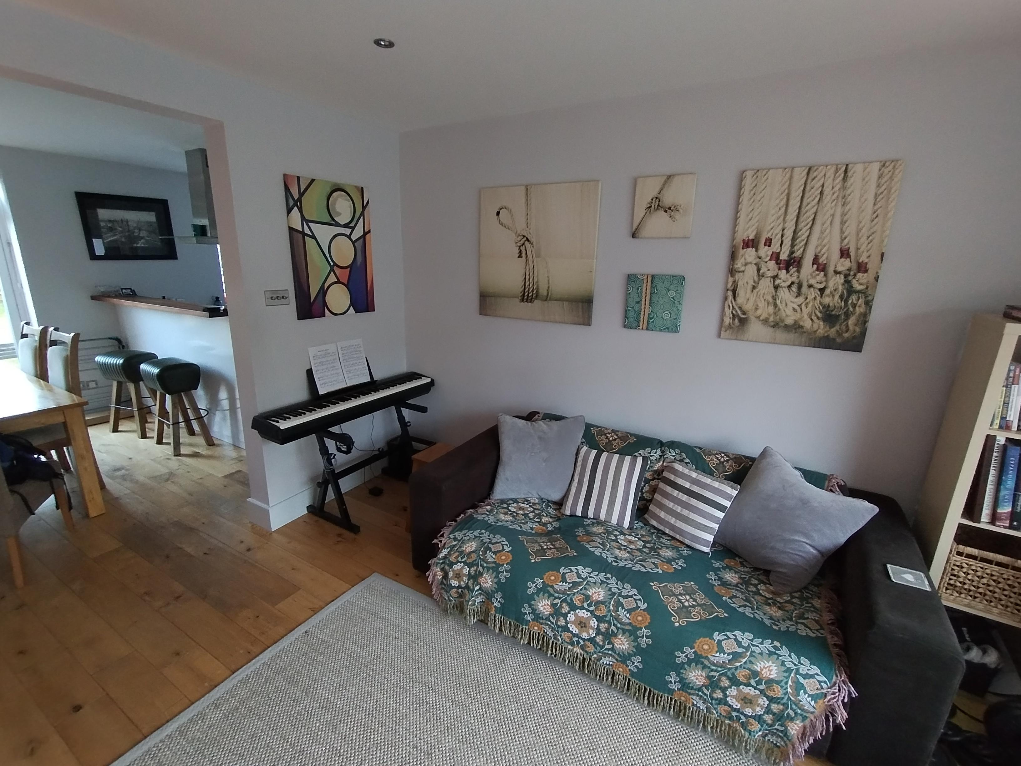 Living room with photo canvases hung about the sofa.