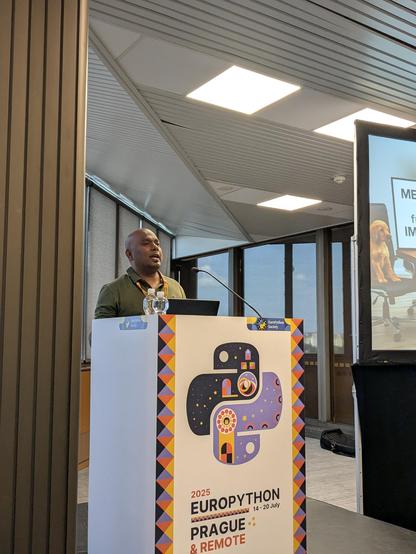 Mani on stage about to start this talk.