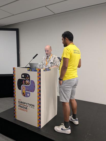 Miguel is getting ready for his talk, supported by one of the many volunteers.