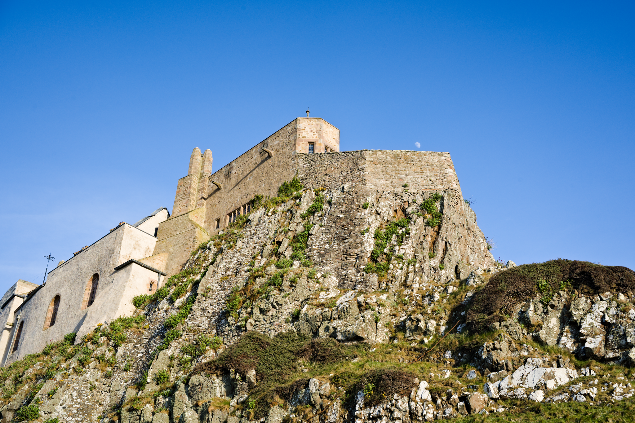 Castle on a rocky outcrop, with blue skies.