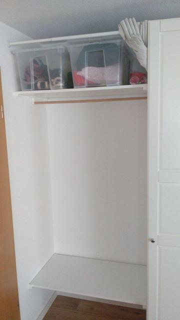 A "wardrobe" in the space between an IKEA PAX and a wall, built from two of these compressed wood planks and a wooden bar to hang jackets from.  On top there are two boxes with shoes and stuff and a curtain can be used to hide everything.