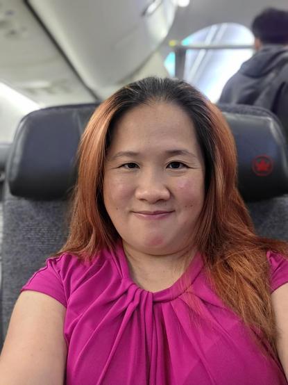 Mariatta seated in an airplane