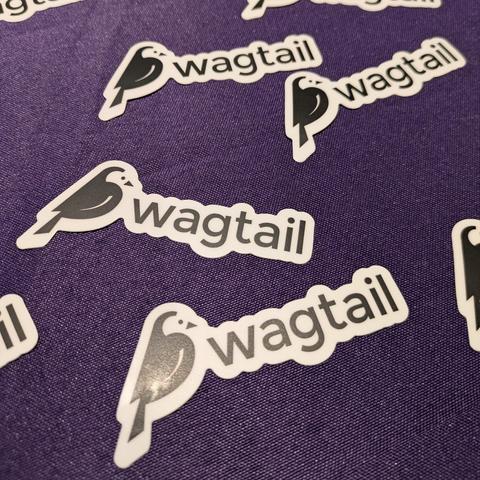 A close up of the Wagtail stickers on the purple tablecloth.