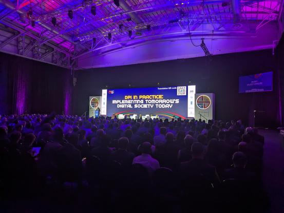 Picture of a stage in a fancy auditorium with Nandan Nilekani of InfoSys