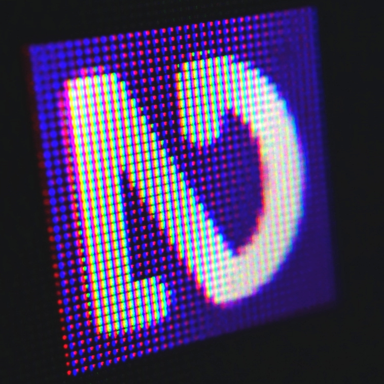 Close up angled photo of NVDA notification area icon with individual pixels visible