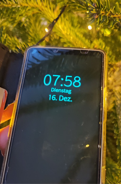 A Sony Xperia 10, screen is black, just clock and date show in a faint cyan color.
