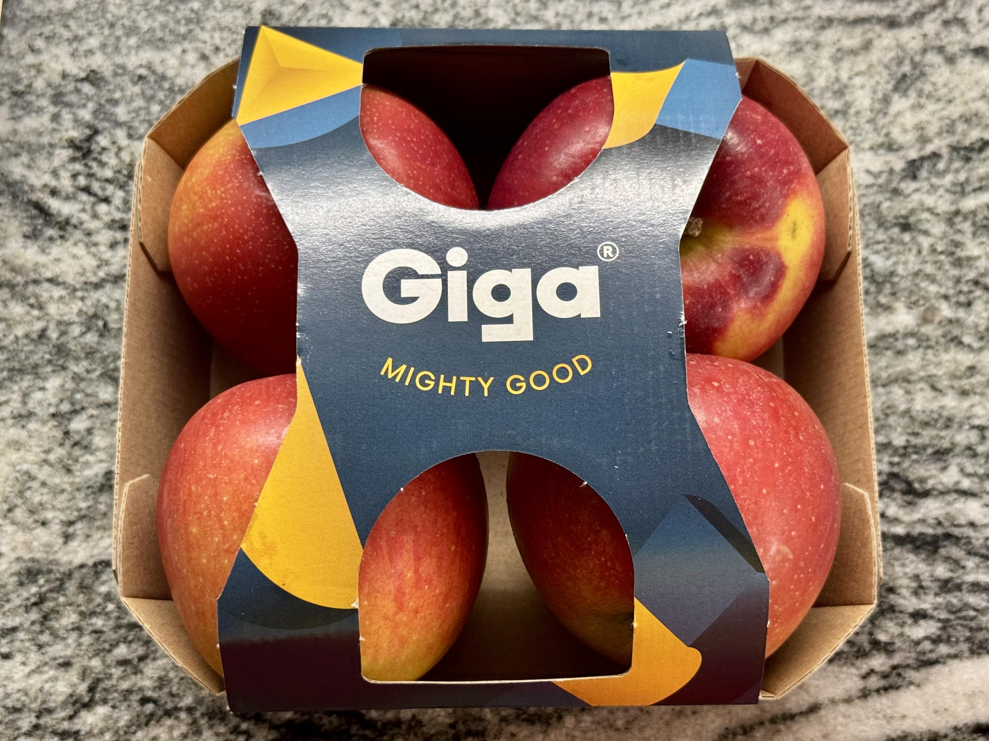 A carton of four “Giga” apples (tagline: “mighty good”)