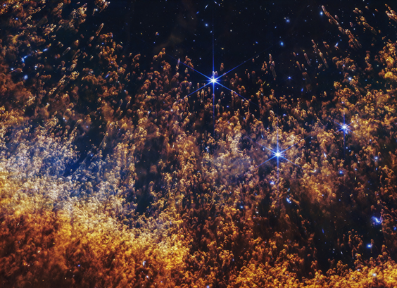 Stars with yellow, finger-like smoky structures of a nebula