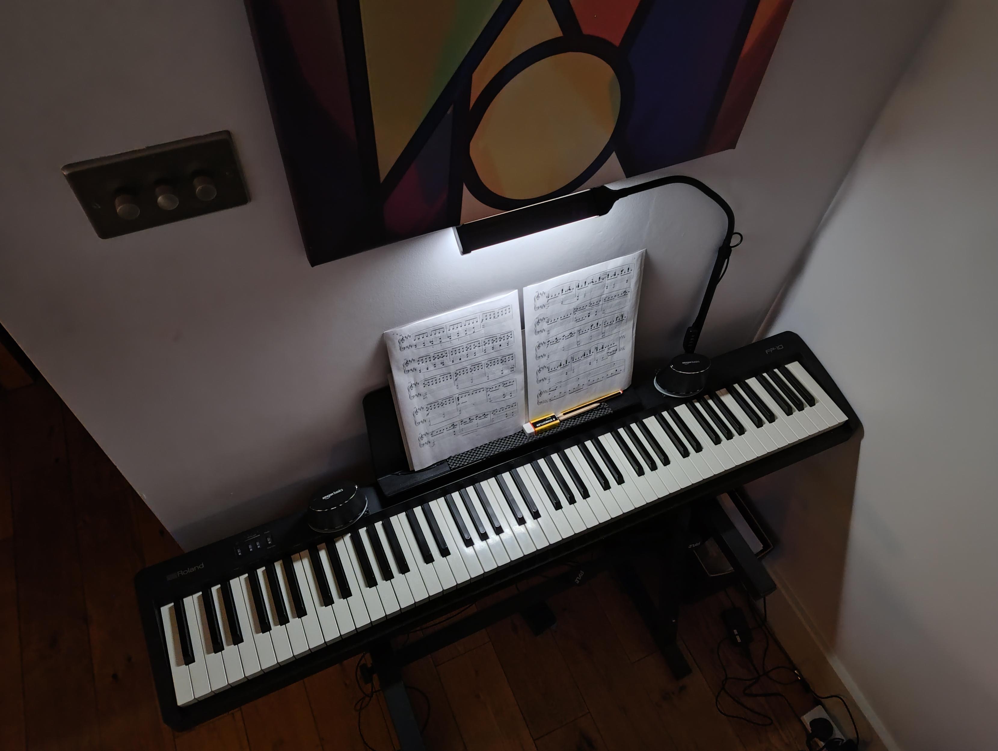LED goose-neck lamp positioned above a digital piano.