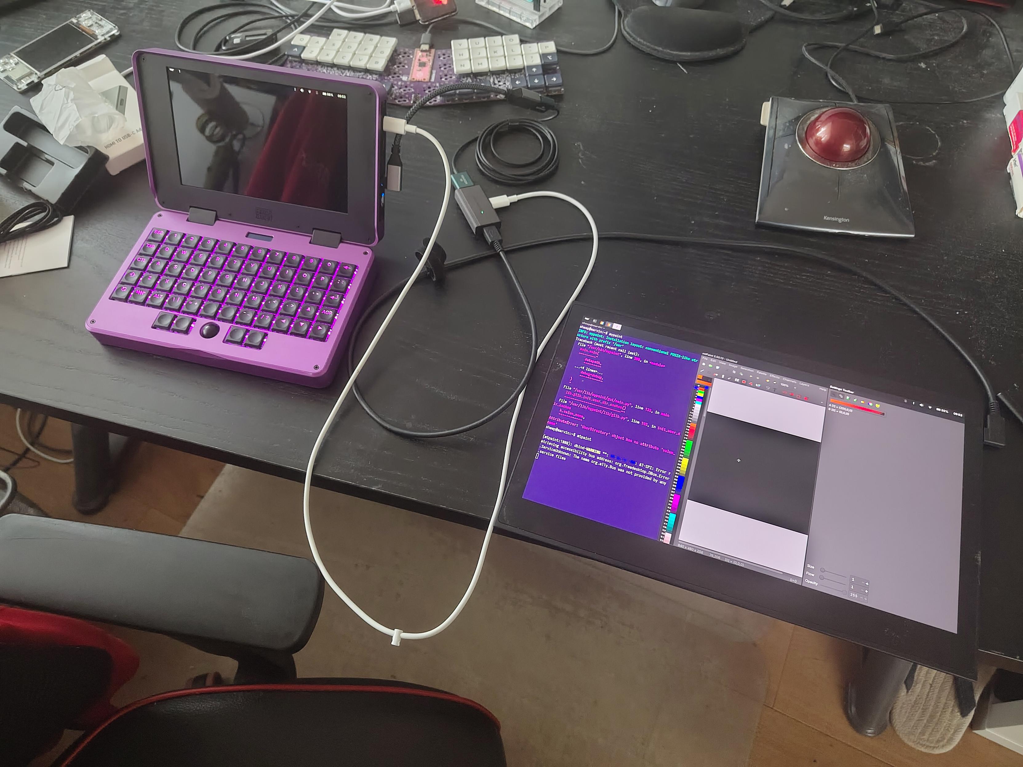 a usb c display connected through a bunch of too long cables and adapters to mnt pocket