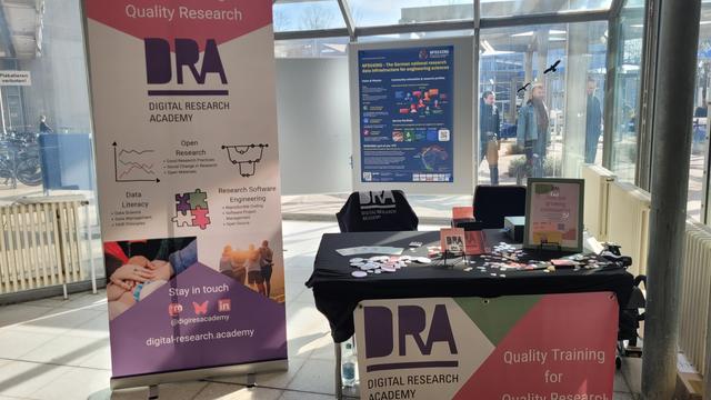 booth of the Digital Research Academy with a banner