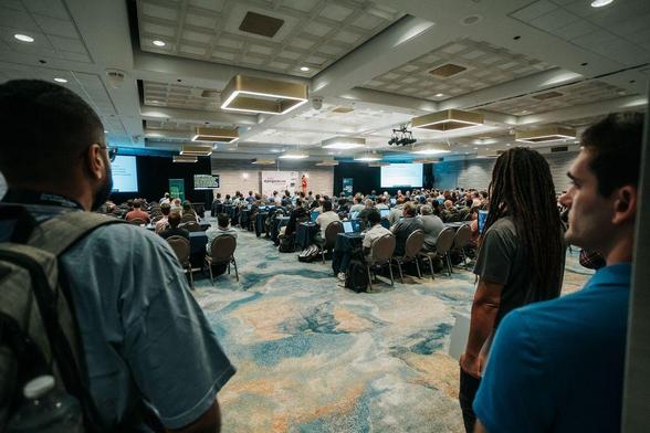 Photo of Zags's keynote at DjangoCon US 2025 in Chicago showing a large crowd watching in the ballroom, by Bartek Pawlik