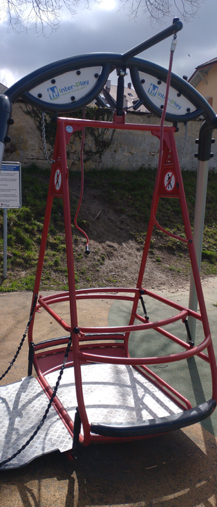 A playground swing specifically for wheelchairs