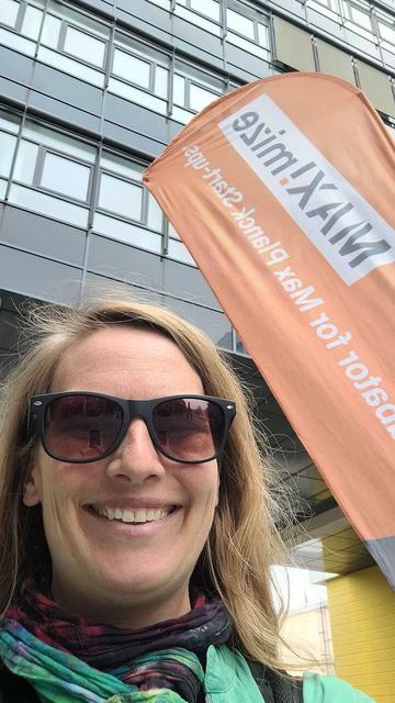 Heidi in front of the MAX!mize banner