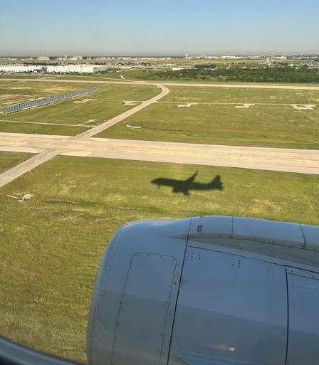 Shadow of plane meeting plane as we touch down for landing