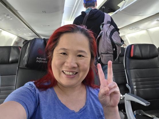 Selfie of mariatta seated inside an airplane