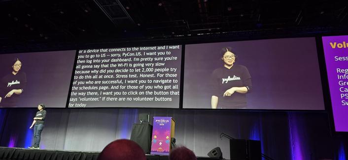 Elaine Wong onstage encouraging PyCon attendees to volunteer