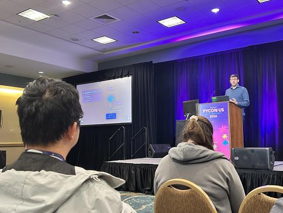Carl Meyer at podium with slide showing one small aspect of a type checker’s internals