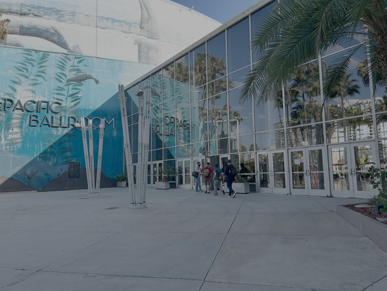 People walking through an open door to the lightning talk area
