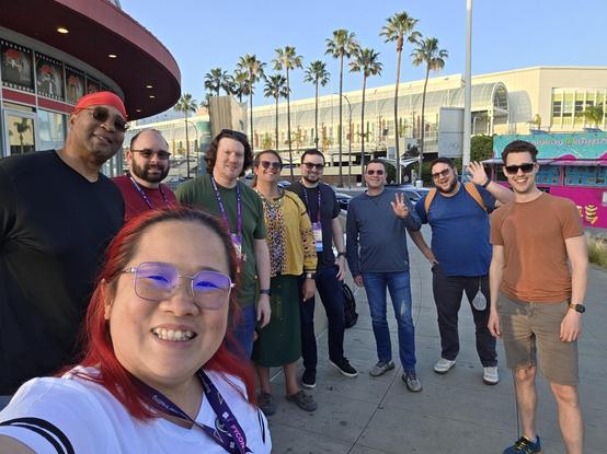 Pierogicon at PyCon US 2026. Group photo with food truck and conference venue and palm trees as background.