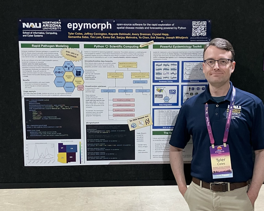 Photo of me standing in front of my PyCon poster about epymorph.