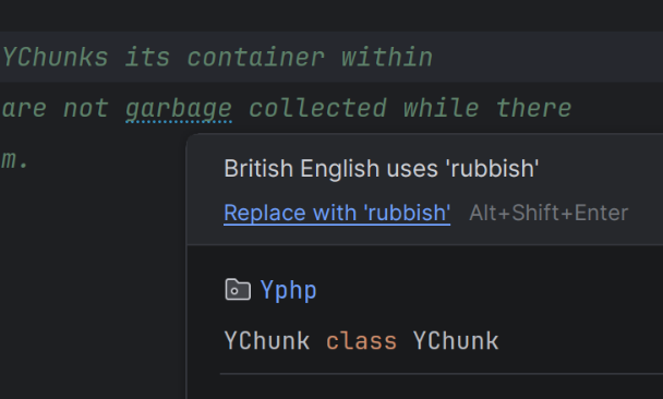A screenshot from PHPStorm, looking at a PHP based code comment, containing the text "garbage collected". The word "garbage" has an underline hint, and the PHPStorm tooltip states: "British English uses 'rubbish'", while offering it change the text to "rubbish collected"