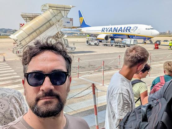 A selfie of me with an airplane in the background 