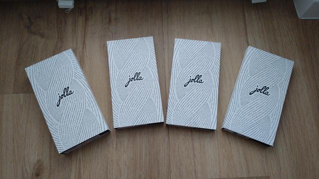 four phone sized cardboard boxes with Jolla logo