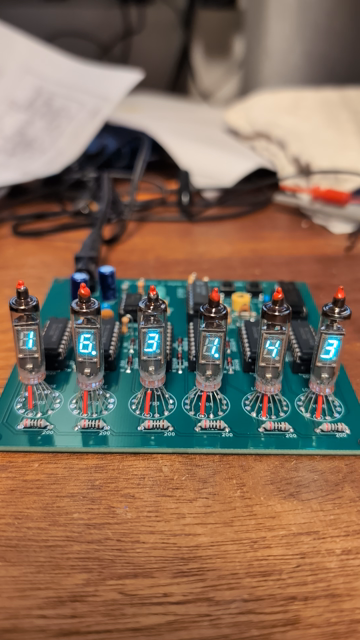 Circuit board with 6 VFD (vacuum florescent display) tubes showing time for a few seconds.