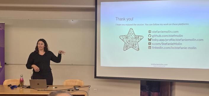Stefanie Molin at PyCon Portugal. She has a slide with qr code in the shape of a star.