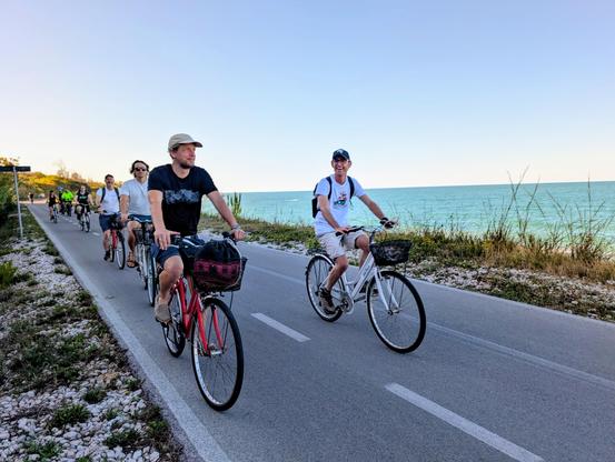 People cycling near the sea