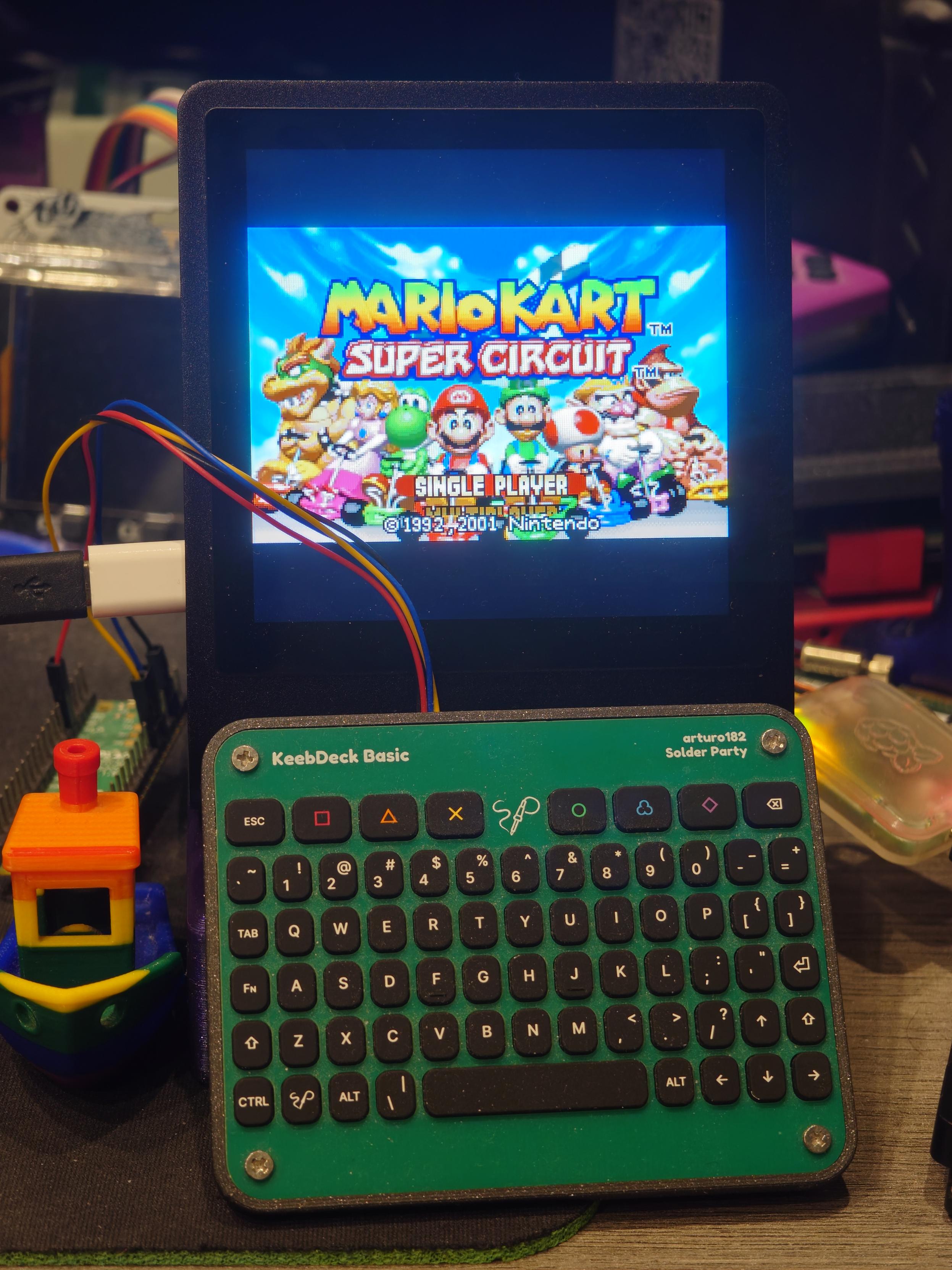 Pimoroni Presto with a Solder Party KeebDeck Basic propped up in front of it. They're roughly the same width.