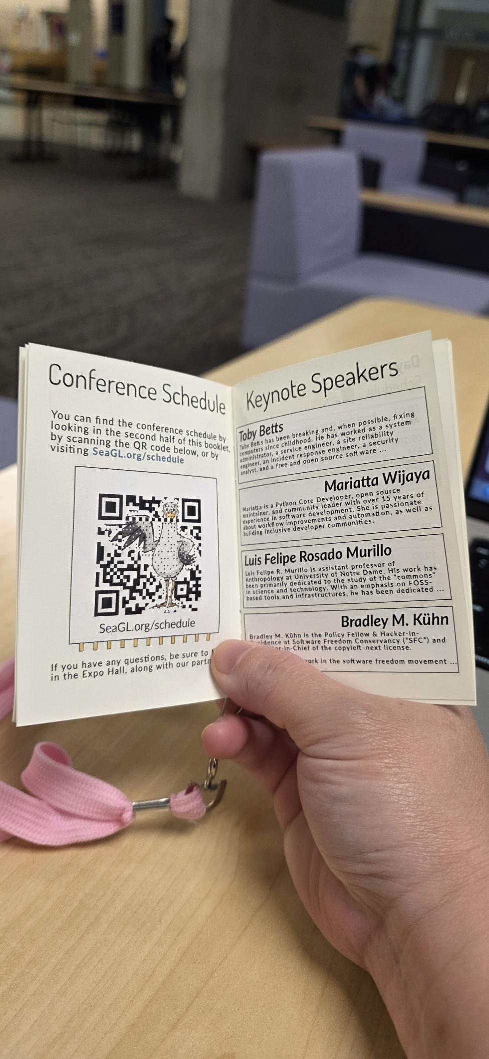 SeaGL 2026 program, in a tiny booklet showing keynote speakers Toby Betts, Mariatta Wijaya, Luis Felipe Rosado Murilo, Bradley M. Kühn