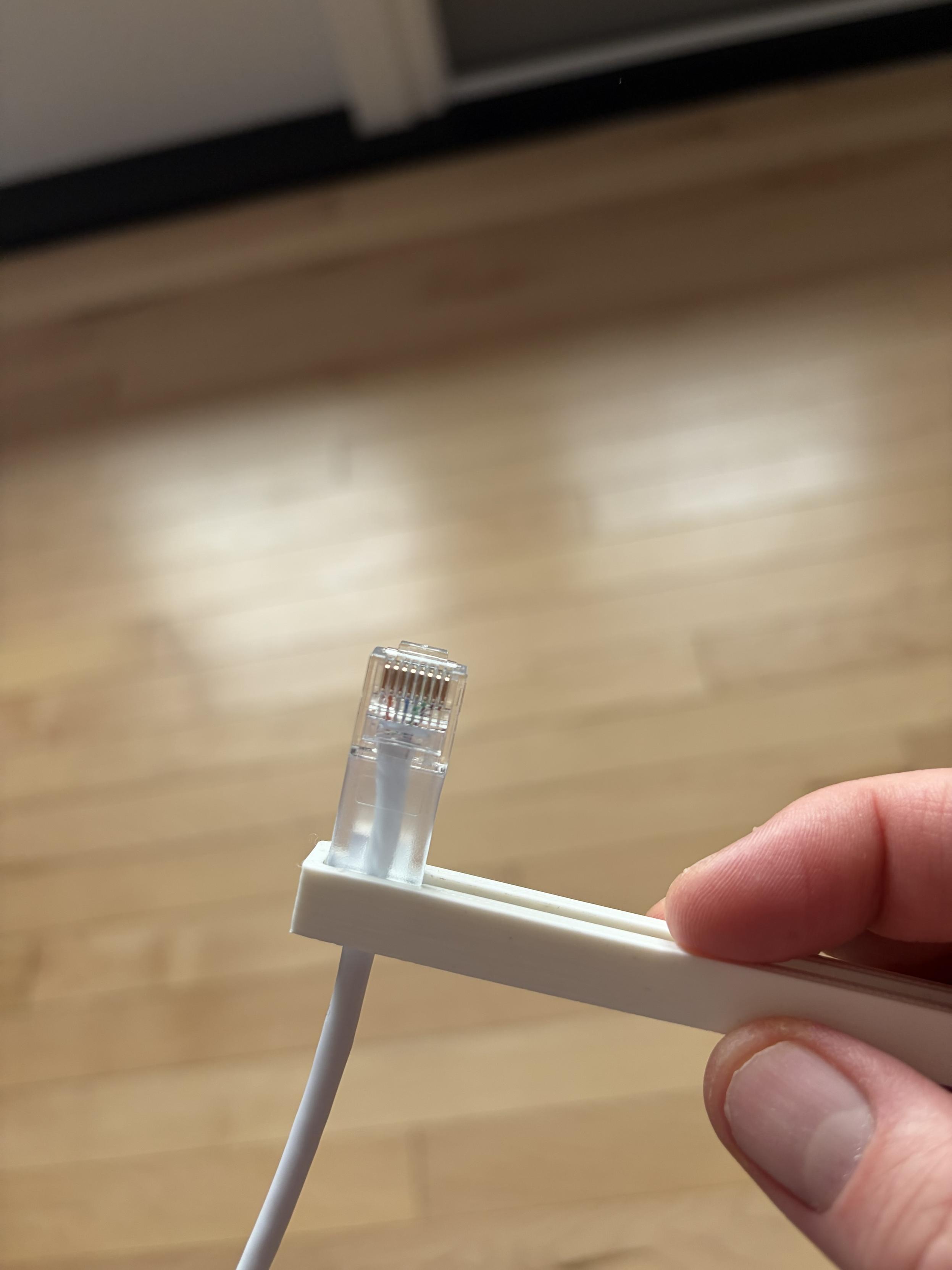 Push it to the other end, it’s tight to the strain relief, allowing you to position the RJ45 accurately.