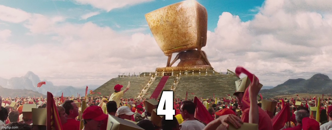 A shot from the movie "The Hitchhiker's Guide to the Galaxy", depicting Deep Thought supercomputer, surrounded by thousands of people cheering. It doesn't say the original "42" answer to the Ultimate Question of Life, the Universe, and Everything. Instead it says "4"