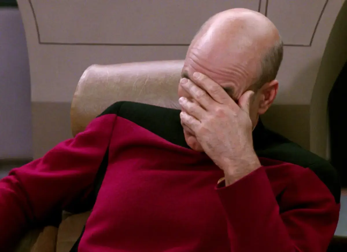 Captain Jean Lyc Picard performing the facepalm on his captains chair.