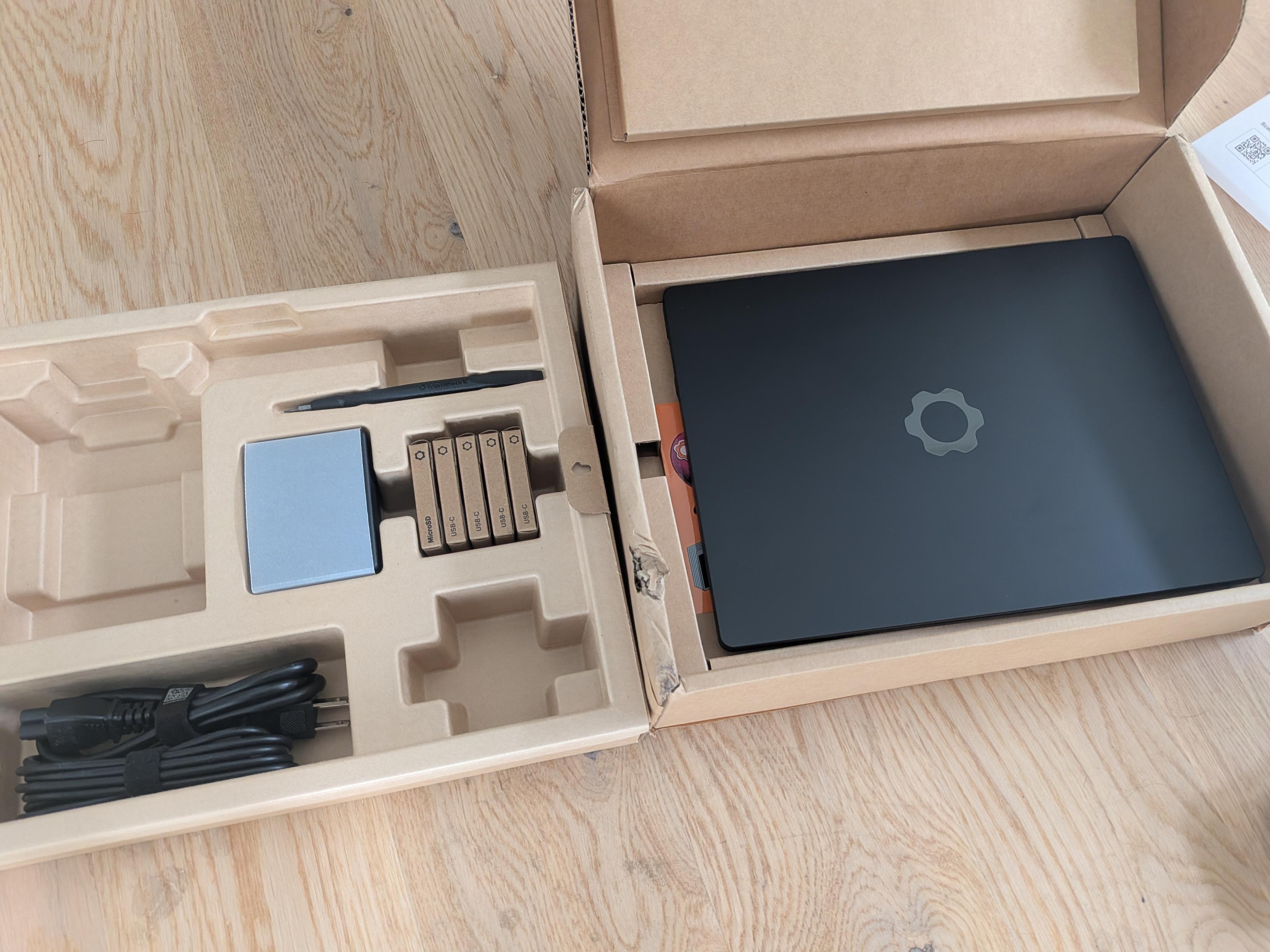 Laptop with accessories in a box.