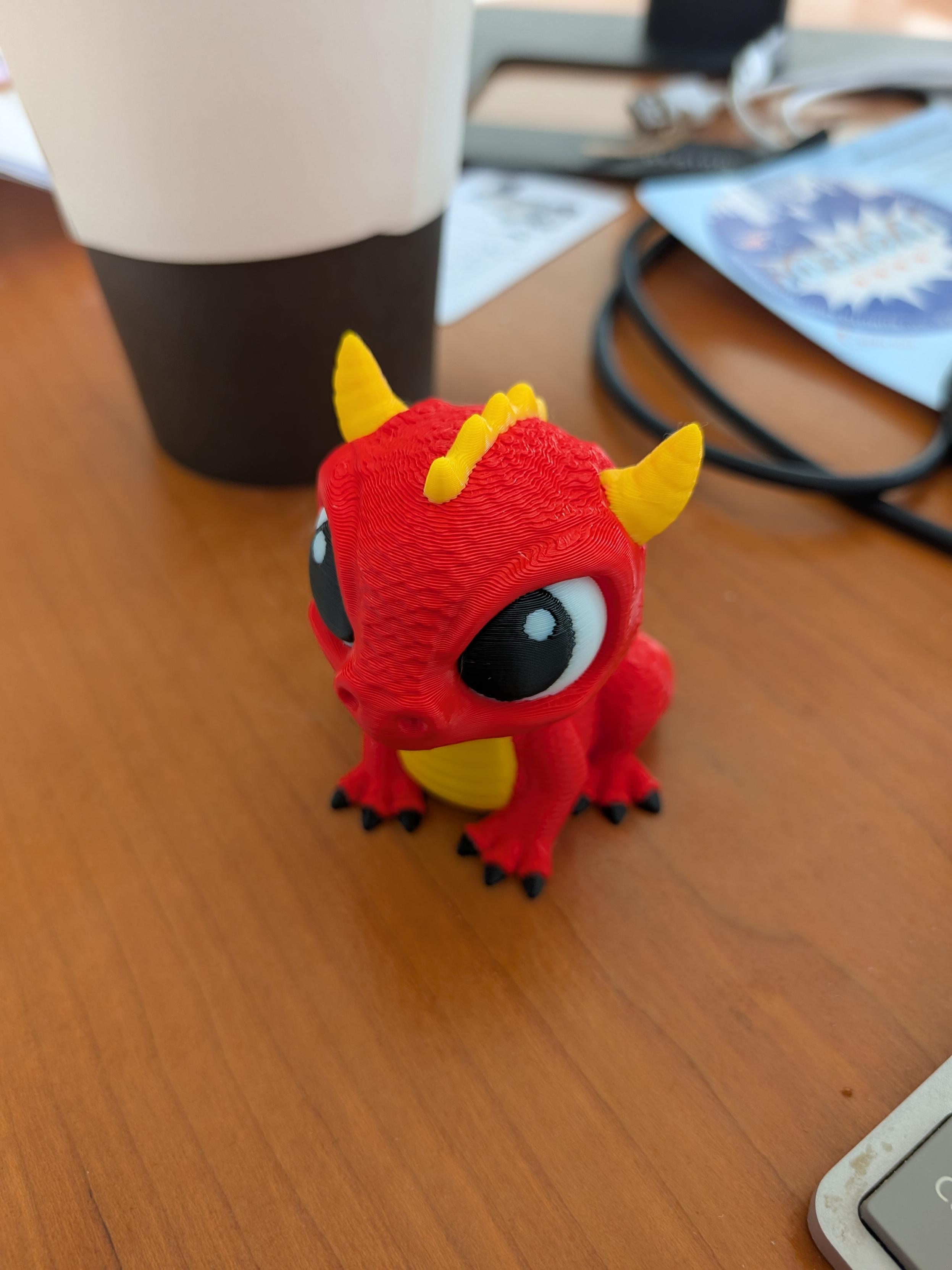 Multi-color filament 3d printed dragon. About 2.5 inches tall.